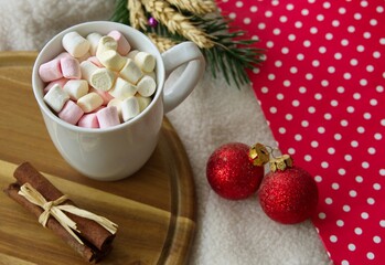 Christmas concept - mug with marshmallows on wooden background