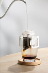 Brewing coffee through pre-made paper filters.