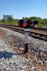 train signal outdoors against the sky with the red light on to stop