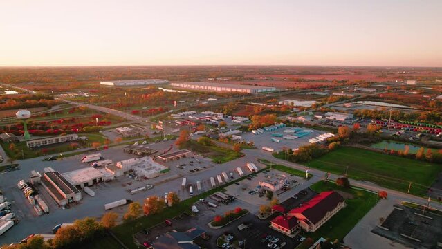 Beautiful high angle of truck stop in fall season at sunset. Semi truck drivers parked waiting for dispatcher call. Monee, IL