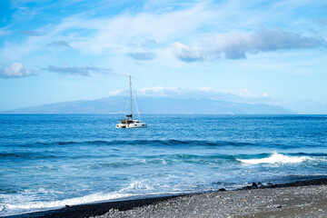 Catamaran close to beach with La Gomera island on the background