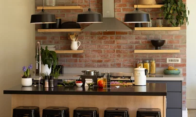 Foto op Canvas Domestic kitchen with shelves and hood over hob on exposed brick wall and hanging lamps over island © WavebreakMediaMicro