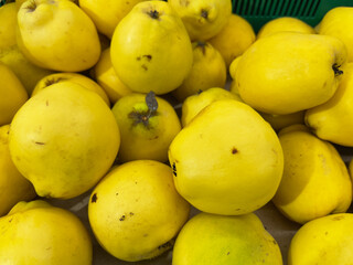Fresh quince fruit in the market, closeup of photo.