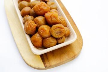Pickled plums on white background.