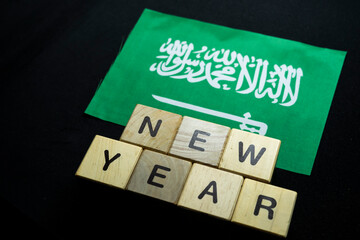 New year to Saudi Arabian people with Saudi Arabia flag on banner