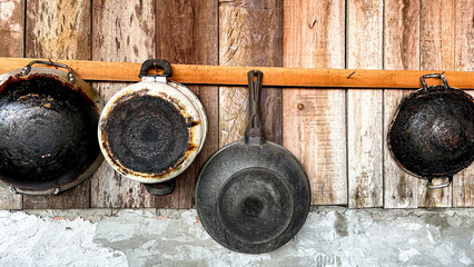 old cooking utensils hanging on the wooden wall for stay home lifestyle - Powered by Adobe