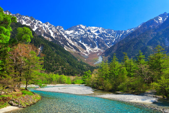 Clear stream of Azusa River and lingering snow on the Hodaka mountain range from Kappa-bashi Bridge in Kamikochi , Japan,Nagano Prefecture,Matsumoto, Nagano May 2022