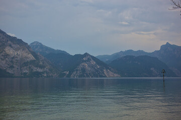 Beautiful foggy and cloudy landscape with a lake and mountains in summer. Natural colorful background. Lake Traunsee is very popular as a health and holiday resort. Gmundnerberg, Upper Austria.