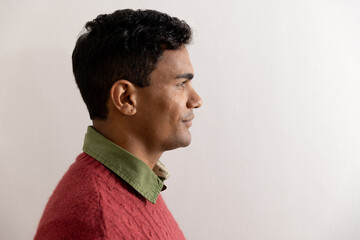 Obraz premium Happy biracial man with black hair over white wall at home