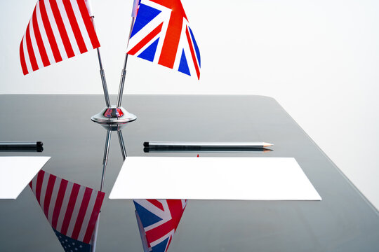 Flags of USA and United Kingdom on negotiation table