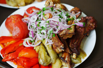Grilled ribs with marinated onions and grilled vegetables. 