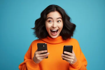 Fotobehang happy asian woman with smartphone face excited © meow