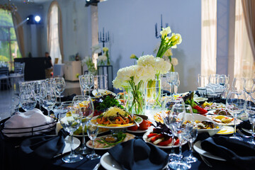 Beautifully set banquet table with black tablecloth. S