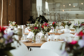 Colorful flowers in a transparent glass vase at a wedding loaction
