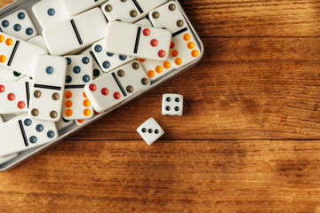 Domino game on brown wooden background close up