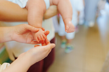 A small child's leg in its mother's arms. 