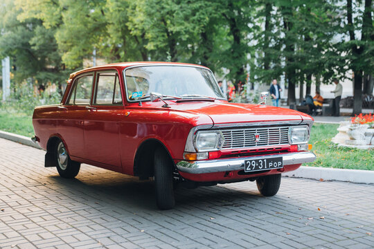 Vintage old red Moskvich car. Soviet automobile industry. 