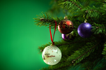 Christmas composition. Balls on a Christmas tree close-up on a green background