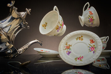 Silver coffeepot and floating coffee cups, Mad Hatter