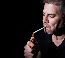 Fototapeta premium middle-aged man lighting a cigarette