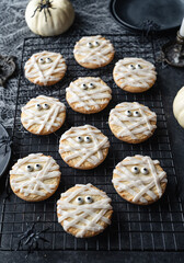 Close up of mummy cookies on baking rack for Halloween.