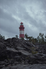 red and white lighthouse on the rock