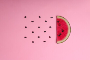 Top view of slice fresh of watermelon with seeds on pink background. 