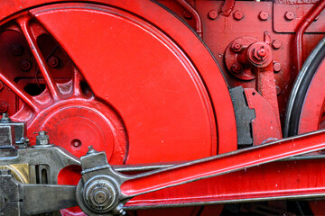 Close-up of a steam locomotive wheel with linkage