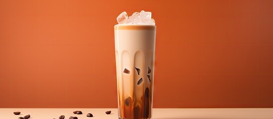 Cream is poured over iced coffee in a tall glass Copy space image Place for adding text or design