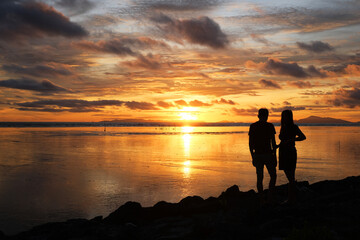 Silhouette of a couple at kampung kuala Kuar Jawa fishing village, Alor setar, Kedah during sunset time.