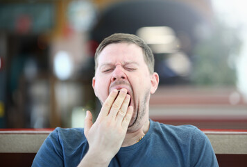 Exhausted Sleepy Male Yawning Facial Portrait. Bored Disheveled Man Closing Gape Mouth with Hand. Drowsy and Bored Person. Adult Tired Guy with Closed Eyes Want to Sleep Close-up Photography.