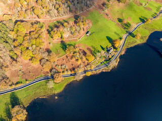 Aerial image of Rydal water lake in the lake district national park and the lake side road , United kingdom on a beautiful autumn day. 