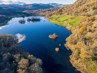 Fototapeta premium Aerial image of Rydal water lake in the lake district national park, United kingdom on a beautiful autumn day. 
