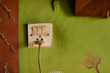 old outlet on green wall