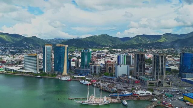Hyperlapse aerial view of the vibrant Caribbean city of Port of Spain, Trinidad and Tobago with an amazing cloudscape in the background
