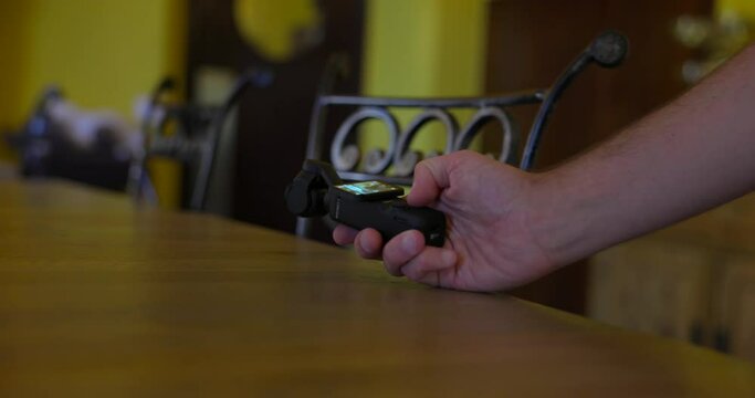 Vlogger recording on table surface with DJI Osmo Pocket 3 stabilized handheld gimbal mobile camera