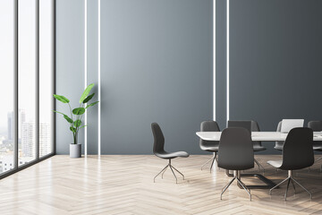 Modern meeting room interior with table and chairs, wooden flooring and panoramic window with city view. 3D Rendering.