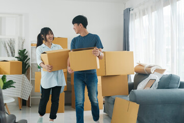 Fototapeta na wymiar Asian young happy new married couple moving to their new house or real estate.