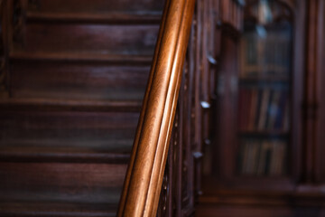 warm gloomy background, detail of a classic interior, wooden staircase railings