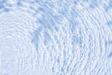 Obraz premium Background summer natural blue texture, clear water with ripples and splashes. Water waves in sunlight with leaf shadow, and background concept of cosmetics, moisturizer, and toner.