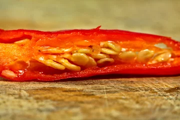 Fotobehang Choped the cayenne pepper on a wooden cutting board.  © Sesat_pictures