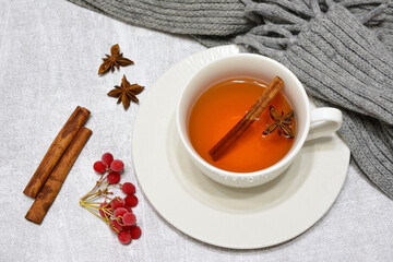 hot cinnamon tea in white cup with saucer top view 