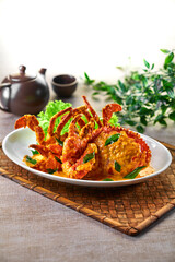 traditional chinese wok fried seafood fresh big meat crab with salted egg yolk paste pumpkin milk sauce in plate on grey vintage background asian cafe hotel luxury halal food restaurant banquet menu