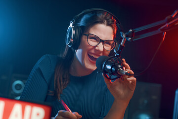 Cheerful woman hosting a radio show