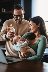 Family, adoption, baby, parenthood and people concept. Happy mother father with newborn baby at home