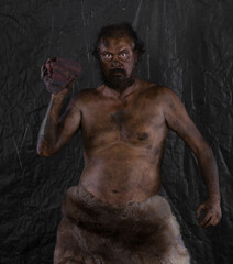 Fototapeta na wymiar caveman with stone in cave