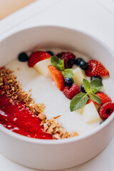 Sweet milk semolina porridge with strawberries on beautiful plate. Delicious breakfast for children