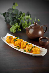traditional chinese seafood big tiger fresh prawn with salted egg yolk sauce in plate pot on grey vintage background asian cafe hotel luxury halal food restaurant banquet menu