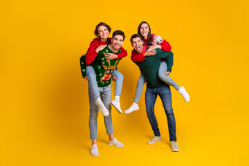 Photo of four best buddies people have fun on christmas event occasion piggyback isolated shine color background