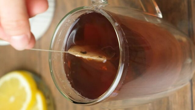 Preparation tea from a tea bag in a glass cup.